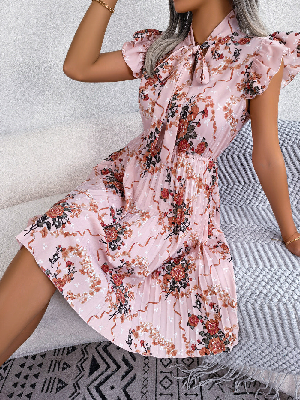 pleated floral printed tie neck knee length dress